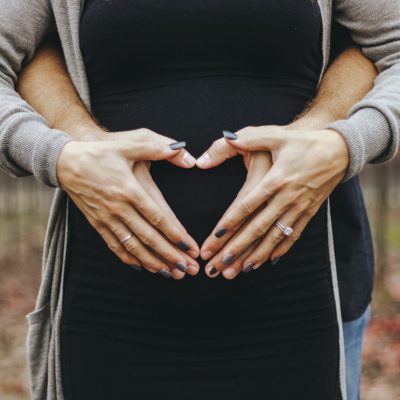 heart hands over pregnant belly